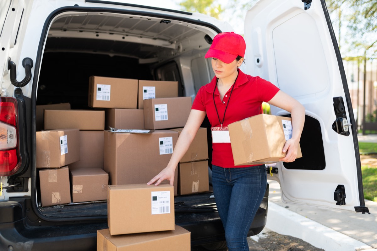 Delivery person handling packages at a loading dock