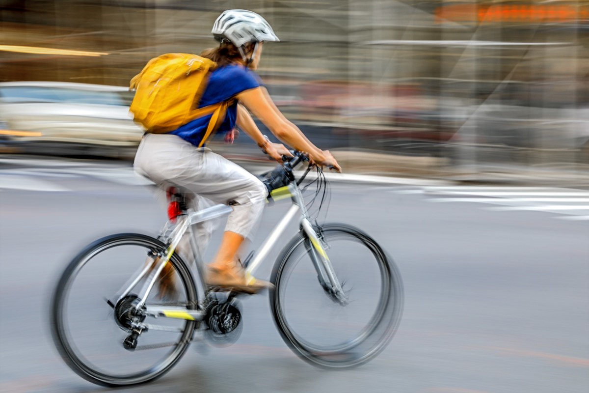 Cyclist making a delivery in a busy urban street